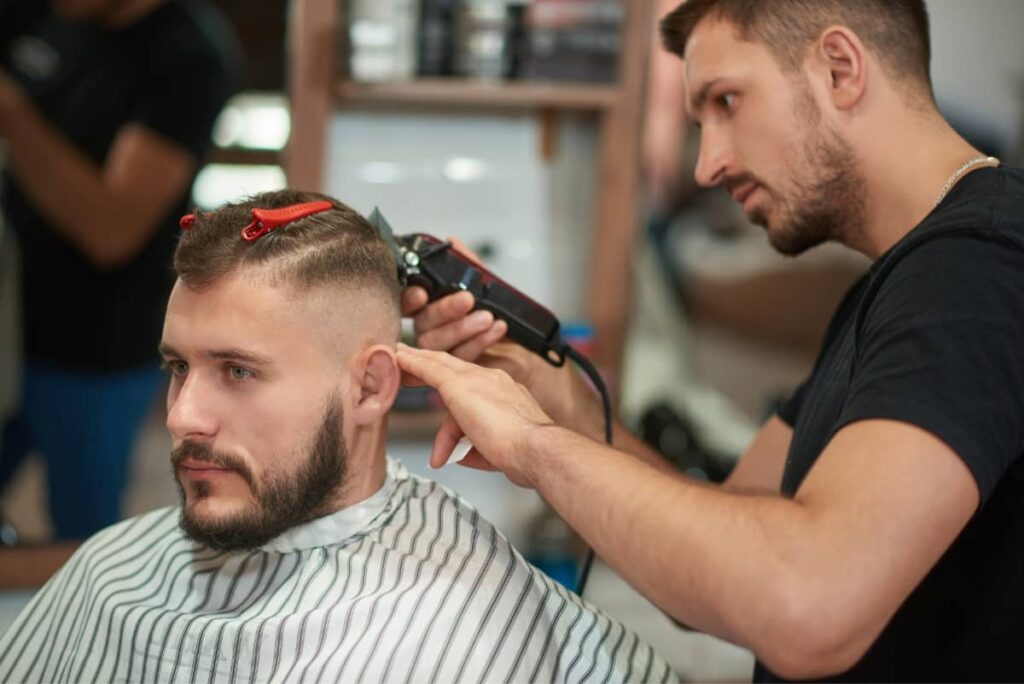 Top G Baber, Barber shaving client's hair