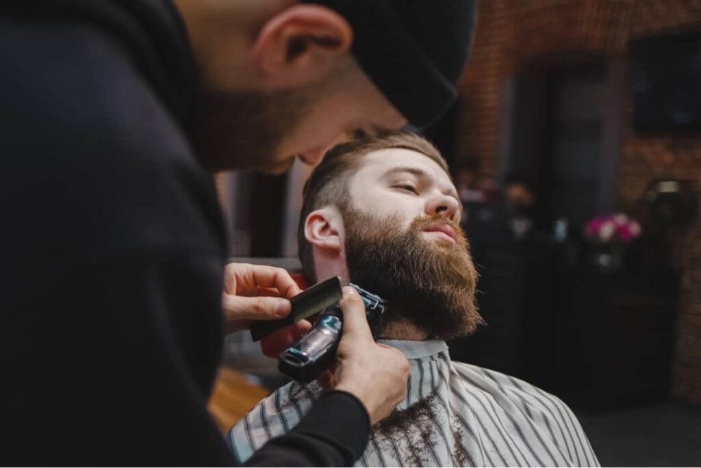 Top G Barber, Barber shaving client's beard